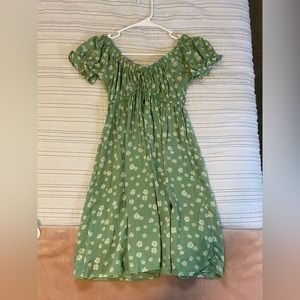 green sundress with small white daisies. it can be worn off or on the shoulder